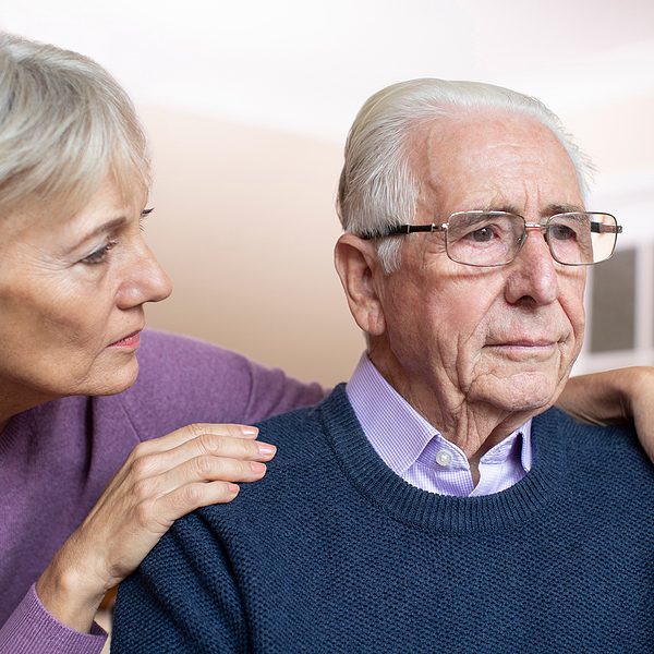 Confused Senior Man Suffering With Depression And Dementia Being Confused Senior Man Suffering With Depression And Dementia Being Comforted By Wife
