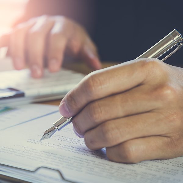 Accountant working on calculator to calculate accounting and business finance plan sales. Business accounting, business investment advisor consulting on the financial report, plan a marketing plan at business office. Business accounting plan concept.