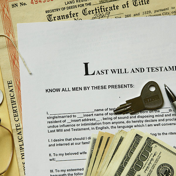 last will and testament with dollar certificate and key.