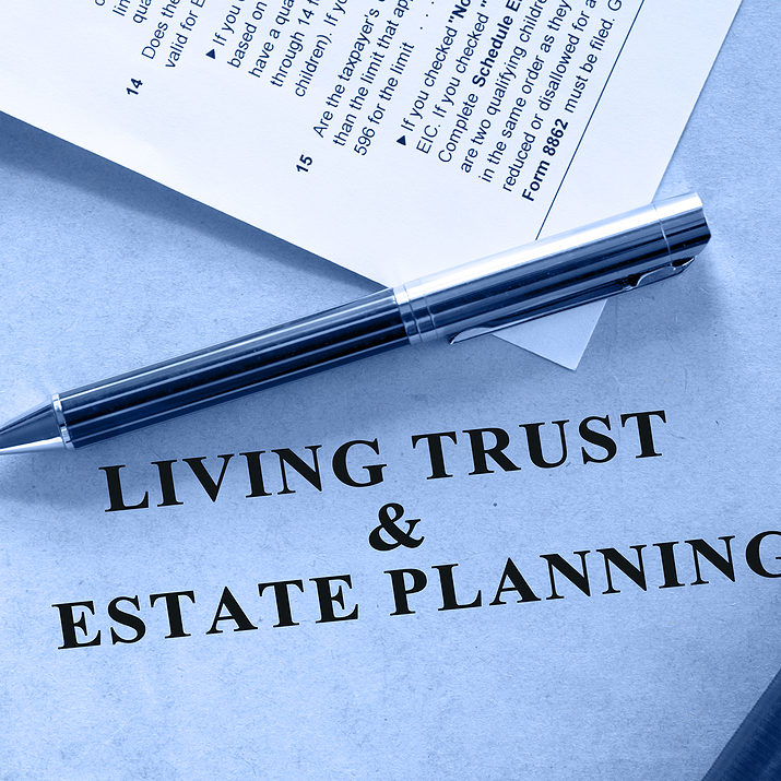 Blue shaded image of living trust and estate planning document. A tax form is also included in the scene.